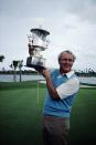 <p>Arnold Palmer of the USA lifts the winning trophy. (Photo by Brian Morgan/Getty Images) </p>