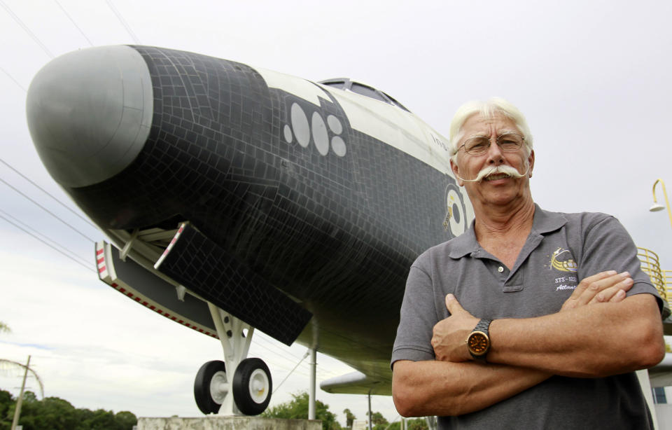 In this Wednesday, July 11, 2012 photo, former space shuttle worker Terry White poses in front of a mock space shuttle at the Astronaut Hall of Fame in Titusville, Fla. White was a project manager who worked 33 years for the shuttle program until he was laid off after Atlantis landed last July 21. (AP Photo/John Raoux)