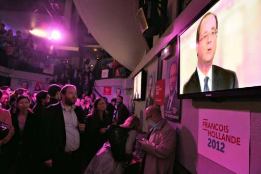 Socialist party loyalists gather to watch on TV the televised national debate between Francois Hollande and Nicolas Sarkozy at the Players bar in Paris. Sarkozy launched fierce assaults on his rival Hollande in their pre-poll debate but failed to land a decisive blow