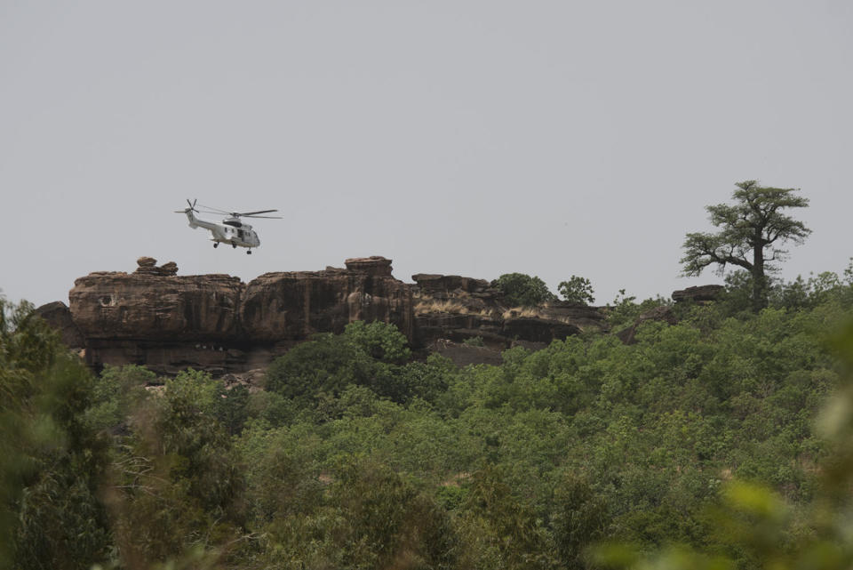 <p>A UN helicopter searches for survivers in the area of Kangaba tourist resort near Bamako on June 19, 2017 after suspected jihadists stormed the resort on June 18, briefly seizing more than 30 hostages and leaving at least two people dead. (Michele Cattani/AFP/Getty Images) </p>