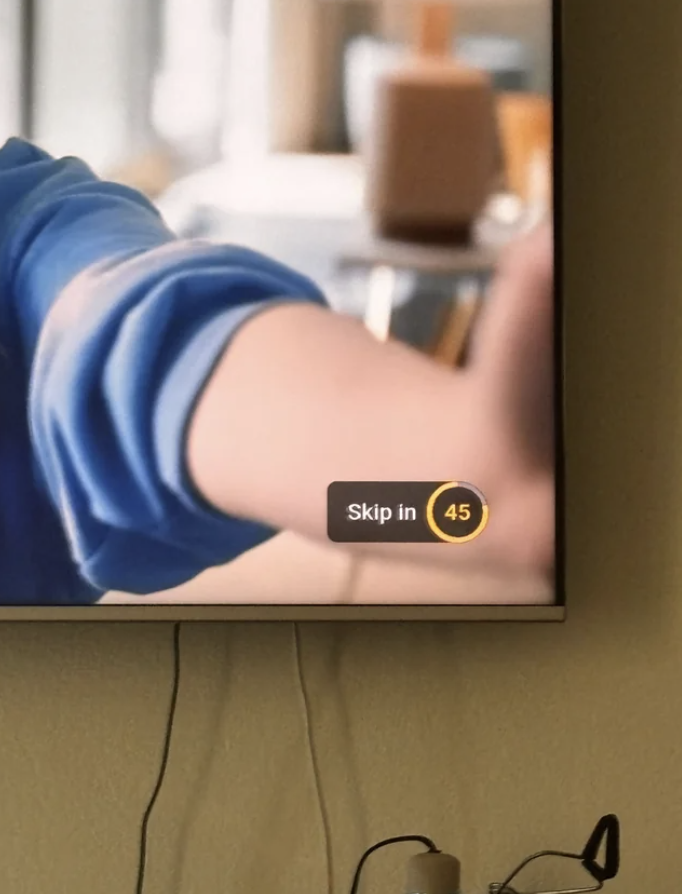 TV screen showing an ad with a 'Skip in 45' seconds button