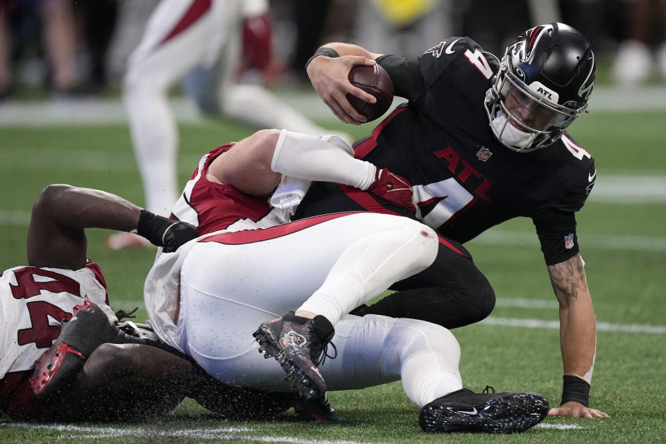 Arizona Cardinals defensive end J.J. Watt (99) sacks Atlanta Falcons quarterback Desmond Ridder (4) during the second half of an NFL football game, Sunday, Jan. 1, 2023, in Atlanta. (AP Photo/John Bazemore)