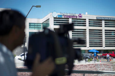 A shadow of a news cameraman is seen in front of the UC Christus Clinical, where is hospitalized the Vatican special envoy Archbishop Charles Scicluna, after a surgery to which he was subjected in Santiago, Chile February 21, 2018. REUTERS/Claudio Santana