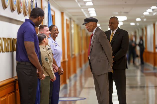 Morgan Freeman speaks to several military personnel.