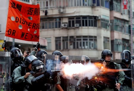 FILE PHOTO: Police officers fire tear gas as anti-extradition bill protesters demonstrate in Sham Shui Po neighbourhood in Hong Kong
