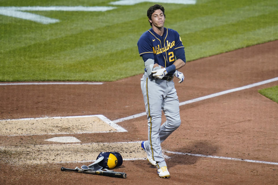 Milwaukee Brewers' Christian Yelich (22) tugs at his padding as he reacts to striking out swinging for the last out of the top of the fifth inning of the team's baseball game against the Pittsburgh Pirates on Tuesday, Aug. 2, 2022, in Pittsburgh. (AP Photo/Keith Srakocic)