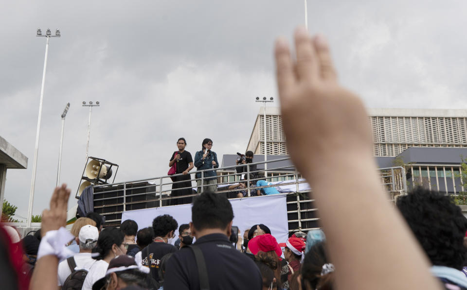 Pro-democracy demonstrators raise a three-finger salute, a symbol of resistance, during a protest outside the Parliament in Bangkok, Thailand, Thursday, Sept. 24, 2020. Lawmakers in Thailand are expected to vote Thursday on six proposed amendments to the constitution, as protesters supporting pro-democratic charter reforms gathered outside the parliament building. (AP Photo/Sakchai Lalit)