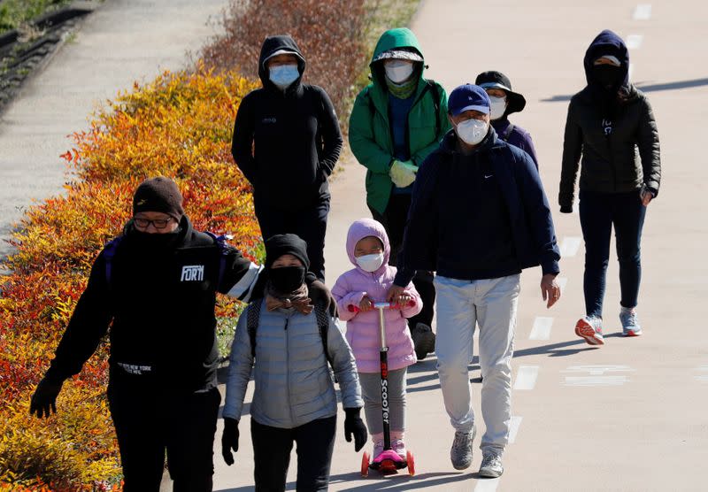 People wearing masks following the rise in confirmed cases of coronavirus disease (COVID-19), take a walk at a park in Daegu