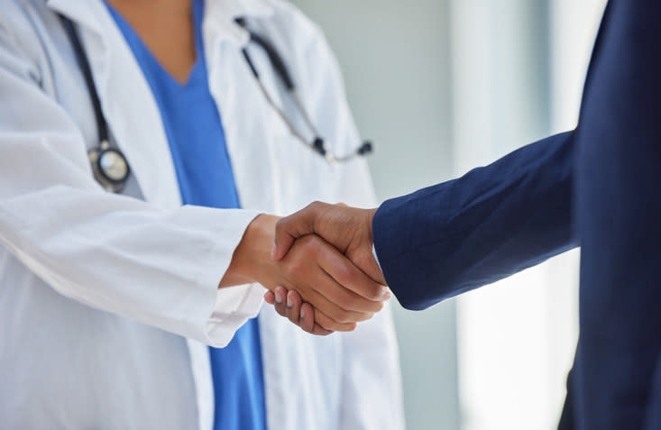 A doctor shaking hands with a pharmaceutical rep