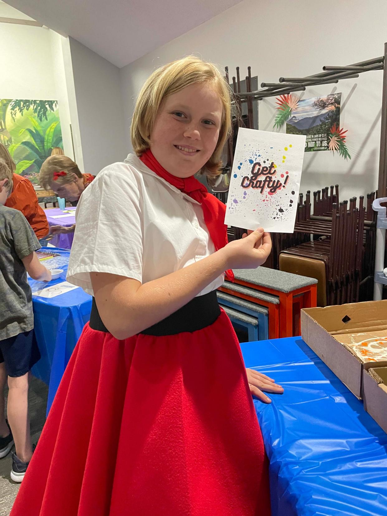 Eliza Saywell stops at the craft table to make a bookmark at the Dancing Through the Decades event sponsored by Joni and Friends Nov. 11 at Fellowship Church.