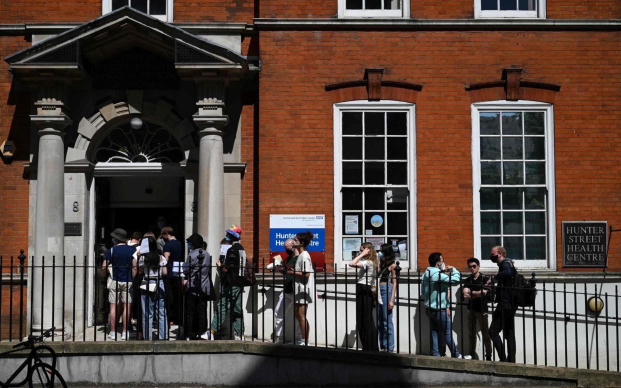 Students queue for Pfizer jabs, the main vaccine offered to anyone under 40, in central London earlier this month - Daniel Leal-Olivas/AFP