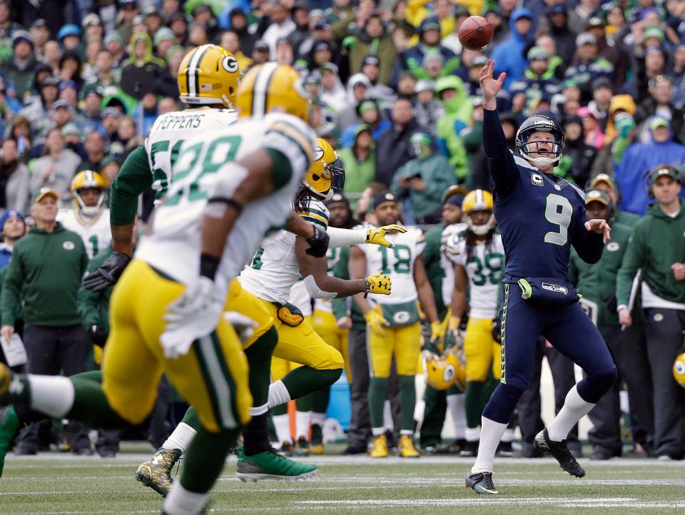 Seattle Seahawks' Jon Ryan throws a touchdown pass on a fake field goal attempt during the second half of the NFC Championship game against the Green Bay Packers Jan. 18, 2015, in Seattle.
