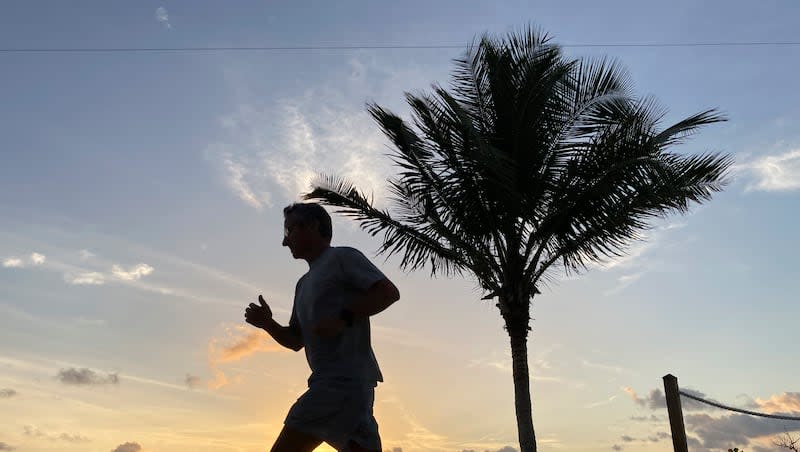 A jogger runs along the beach as the sun rises over the Atlantic Ocean, Thursday, April 6, 2023, in Surfside, Fla. Folks who are “persistently active” have less trouble falling asleep and enjoy higher-quality sleep, according to new research published in the journal BMJ Open.