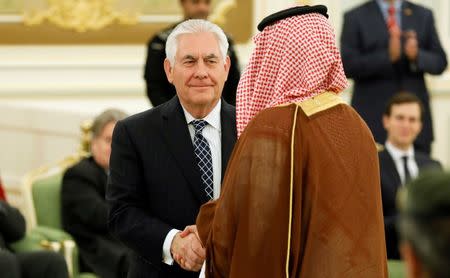 U.S. Secretary of State Rex Tillerson (C) shakes hands with a participant as he attends a signing ceremony between U.S. President Donald Trump and Saudi Arabia's King Salman bin Abdulaziz Al Saud at the Royal Court in Riyadh, Saudi Arabia May 20, 2017. REUTERS/Jonathan Ernst/Files
