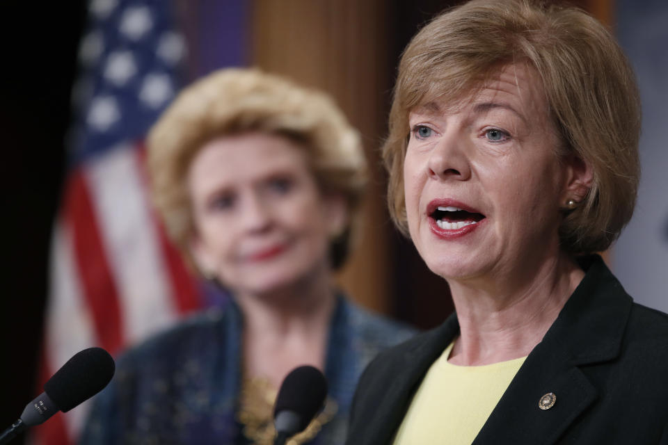 Sen. Tammy Baldwin, D-Wis., right, accompanied by Sen. Debbie Stabenow, D-Mich., speaks on Capitol Hill in Washington, Tuesday, April 25, 2017, during a news conference to discuss President Donald Trump's first 100 days,. (AP Photo/Alex Brandon)