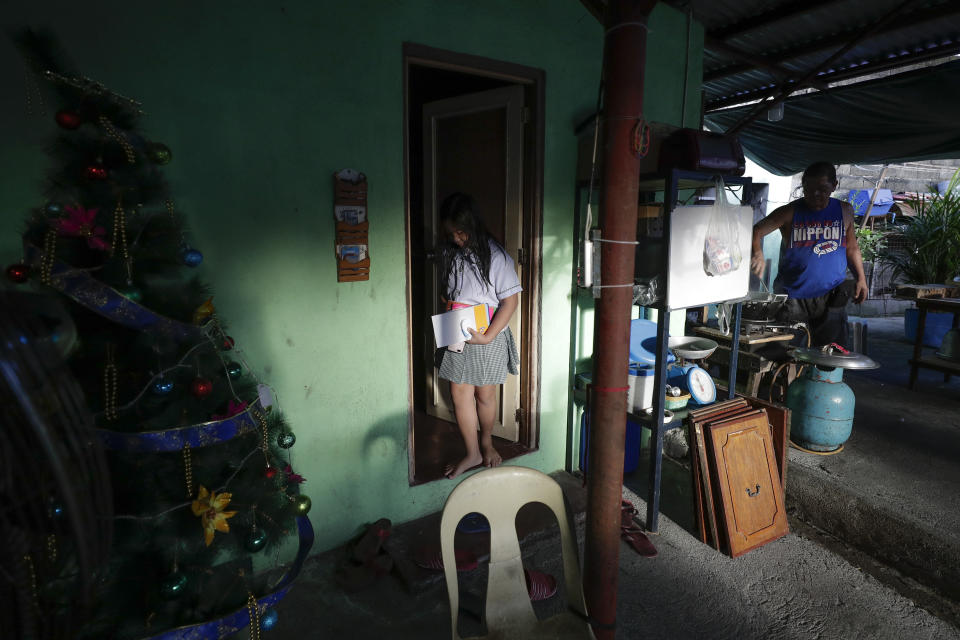 Student Bhea Joy Roxas leaves her home as she prepares for the opening of an online classroom in Quezon city, Philippines on Monday, Oct. 5, 2020. Students in the Philippines began classes at home Monday after the coronavirus pandemic forced remote-learning onto an educational system already struggling to fun schools. (AP Photo/Aaron Favila)