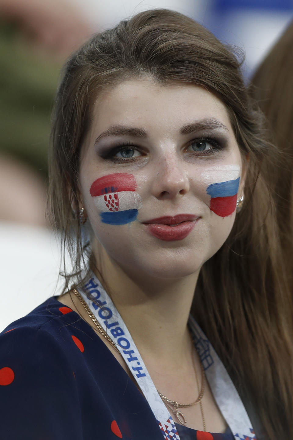 <p>A woman with her face painted with Russia and Croatia flags waits for the start </p>