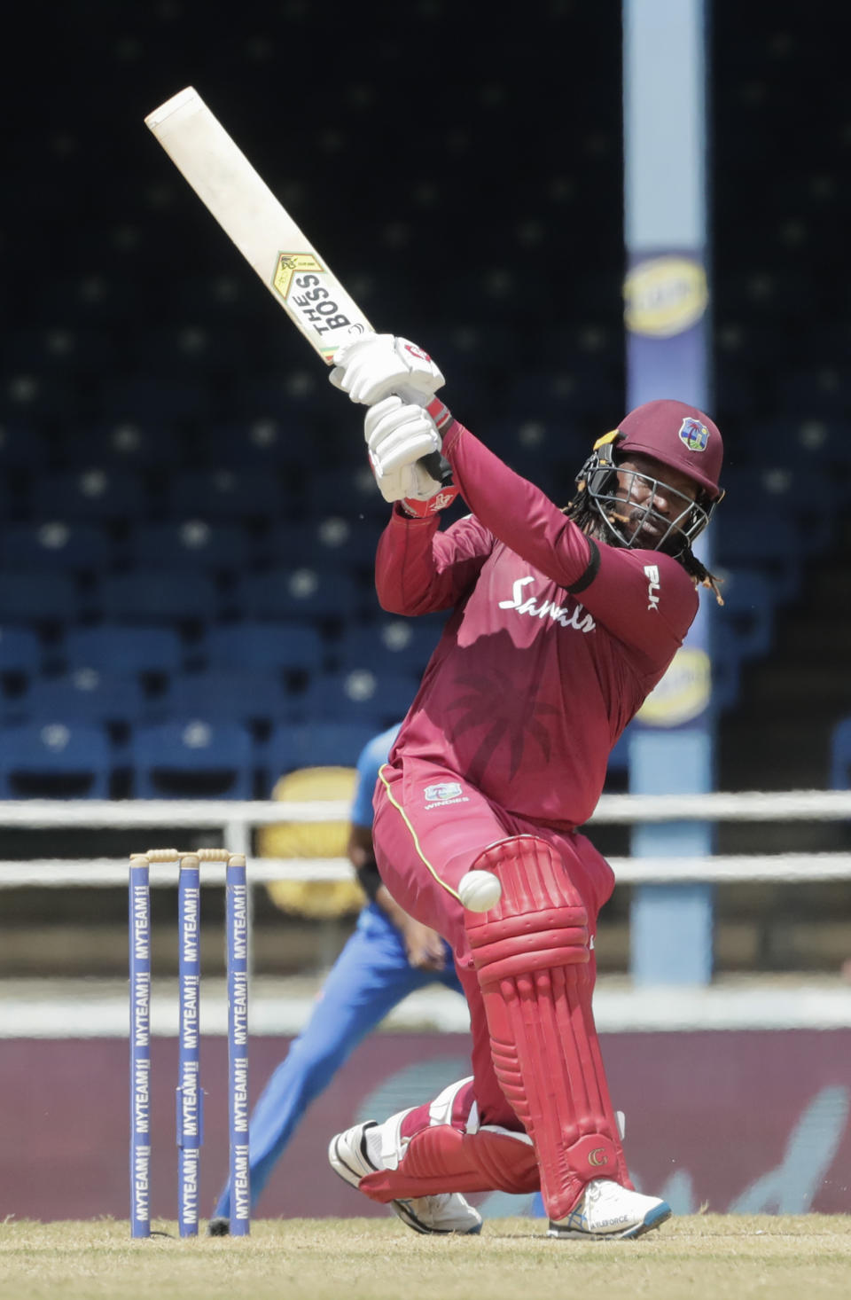 West Indies opening batsman Chris Gayle hit a four during the third One-Day International cricket match against India in Port of Spain, Trinidad, Wednesday, Aug. 14, 2019. (AP Photo/Arnulfo Franco)