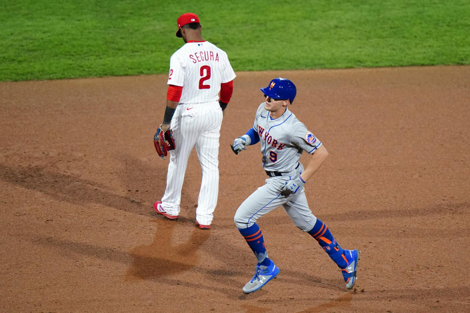 New York Mets' Brandon Nimmo, right, rounds the bases past Philadelphia Phillies third baseman Jean Segura after hitting a home run off pitcher Jake Arrieta during the fifth inning of a baseball game, Tuesday, Sept. 15, 2020, in Philadelphia. (AP Photo/Matt Slocum)