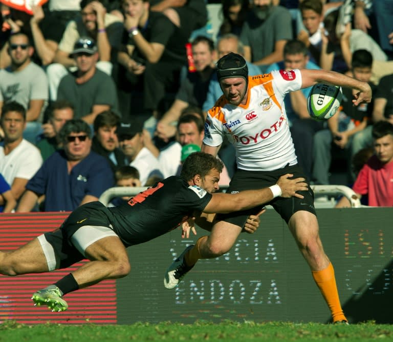 Argentina's Jaguares wing Ramiro Moyano tackles South Africa's Cheetahs flanker Michael Van Der Spuy (R) during their Super Rugby match March 18, 2017