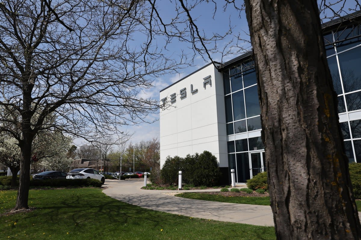 Representative:  A sign marks the location of a Tesla dealership (Getty Images)