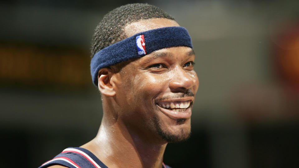 Clifford Robinson smiling during a Nets game.