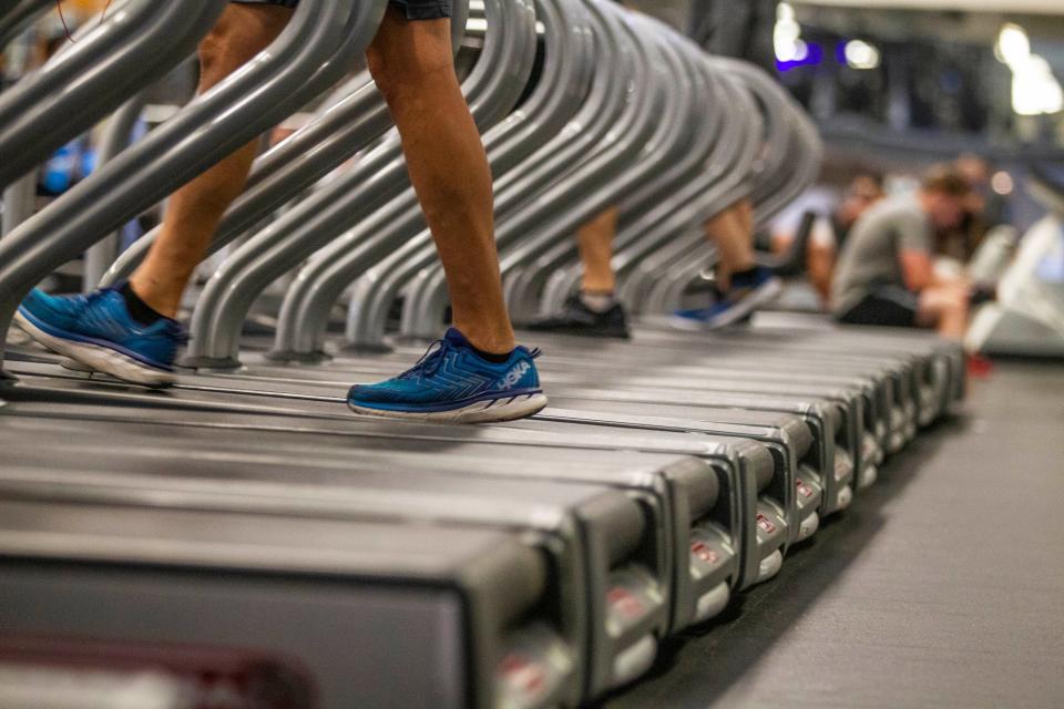 A man walks on a treadmill at Momentum Fitness.