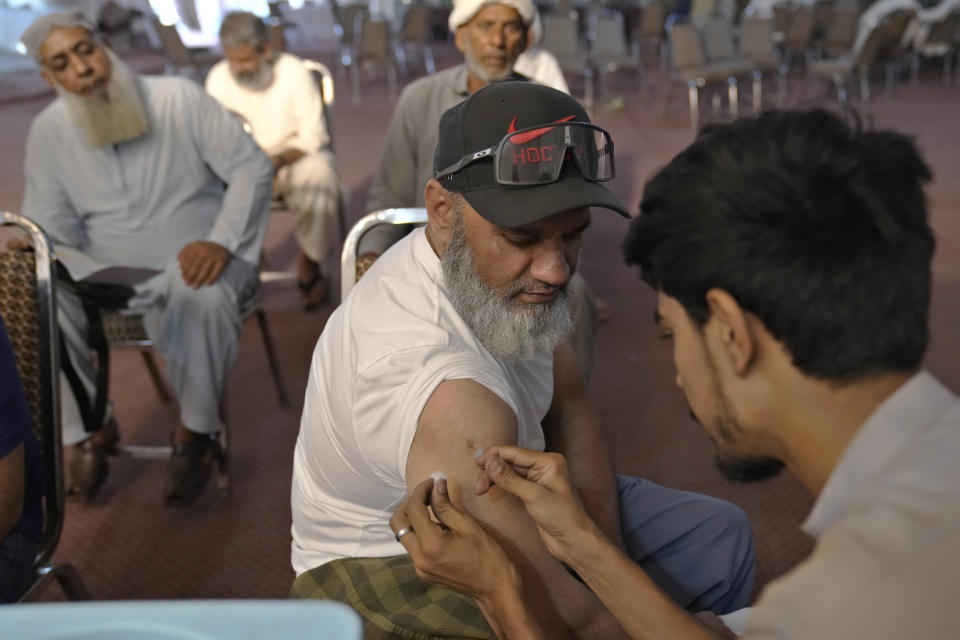 A pilgrim gets quadrivalent influenza vaccine in a Hajj training center in Lahore, Pakistan, Monday, June 19, 2023. Saudi Arabia is hosting its biggest Hajj pilgrimage in three years, starting Monday. But for many pilgrims and others who couldn't make it, global inflation and economic crises made it more of a strain to carry out Islam's spiritual trip of a lifetime. (AP Photo/K.M. Chaudary)