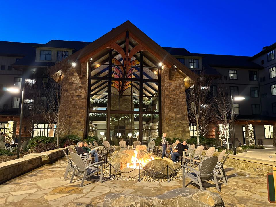 Fire pits surrounded by Adirondack chairs outside of Dollywood HeartSong resort lobby