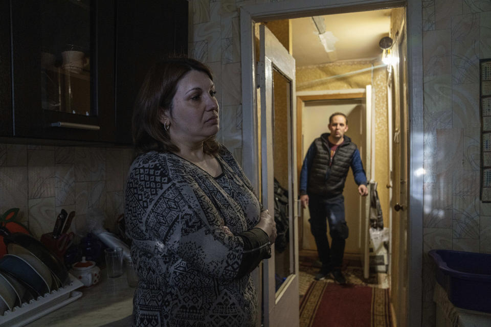 Tatiana and Andriy Cheremushkin stand in their house in Toretsk, eastern Ukraine, Monday, April 25, 2022. Toretsk residents have had no access to water for more than two months because of the war. (AP Photo/Evgeniy Maloletka)