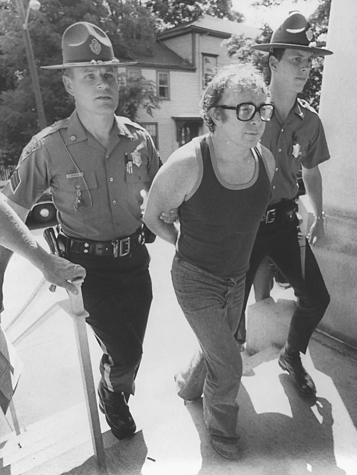 Myles Connor is led into Dedham Superior Court by State Police in July 1985.