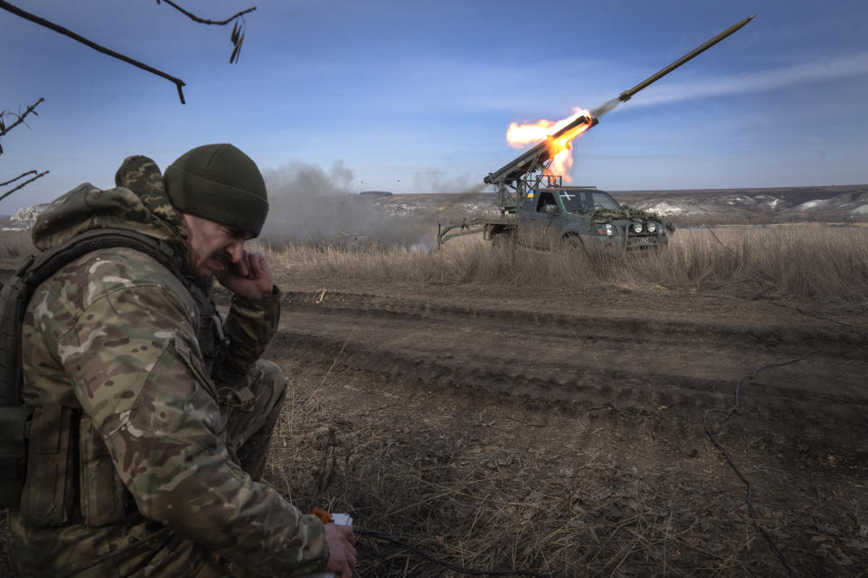 A Ukrainian officer from The 56th Separate Motorized Infantry Mariupol Brigade fires a multiple launch rocket system based on a pickup truck towards Russian positions at the front line, near Bakhmut, Donetsk region, Ukraine, Tuesday, March 5, 2024. (AP Photo/Efrem Lukatsky)