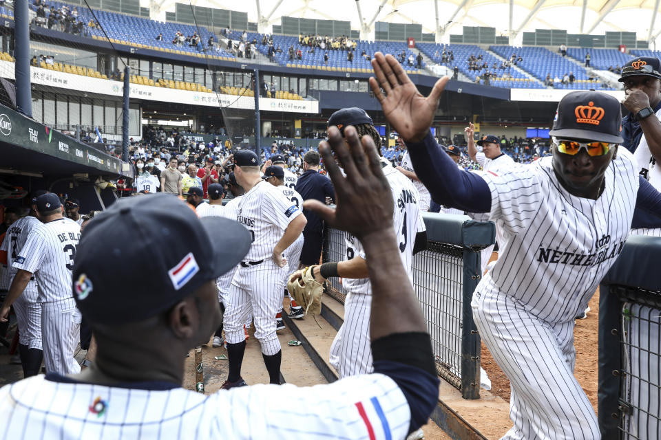 Netherlands infielder Didi Gregorius, right, gives a high five to a teammate to celebrate the team's 4-2 win over Cuba in a Pool A game at the World Baseball Classic (WBC) at Taichung Intercontinental Baseball Stadium in Taichung, Taiwan, Wednesday, March 8, 2023 (AP Photo/I-Hwa Cheng)