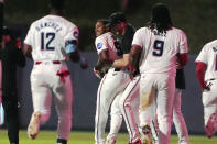 Miami Marlins players rush the field to congratulate Dane Myers after his single drove the winning run during the 10 inning of a baseball game against the Colorado Rockies, Tuesday, April 30, 2024, in Miami. The Marlins defeated the Rockies 7-6. (AP Photo/Marta Lavandier)