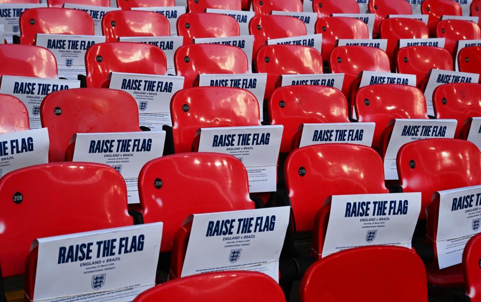 Detailed view of the 'raise the flag' banners placed on seats inside the stadium prior to the international friendly match between England and Brazil at Wembley