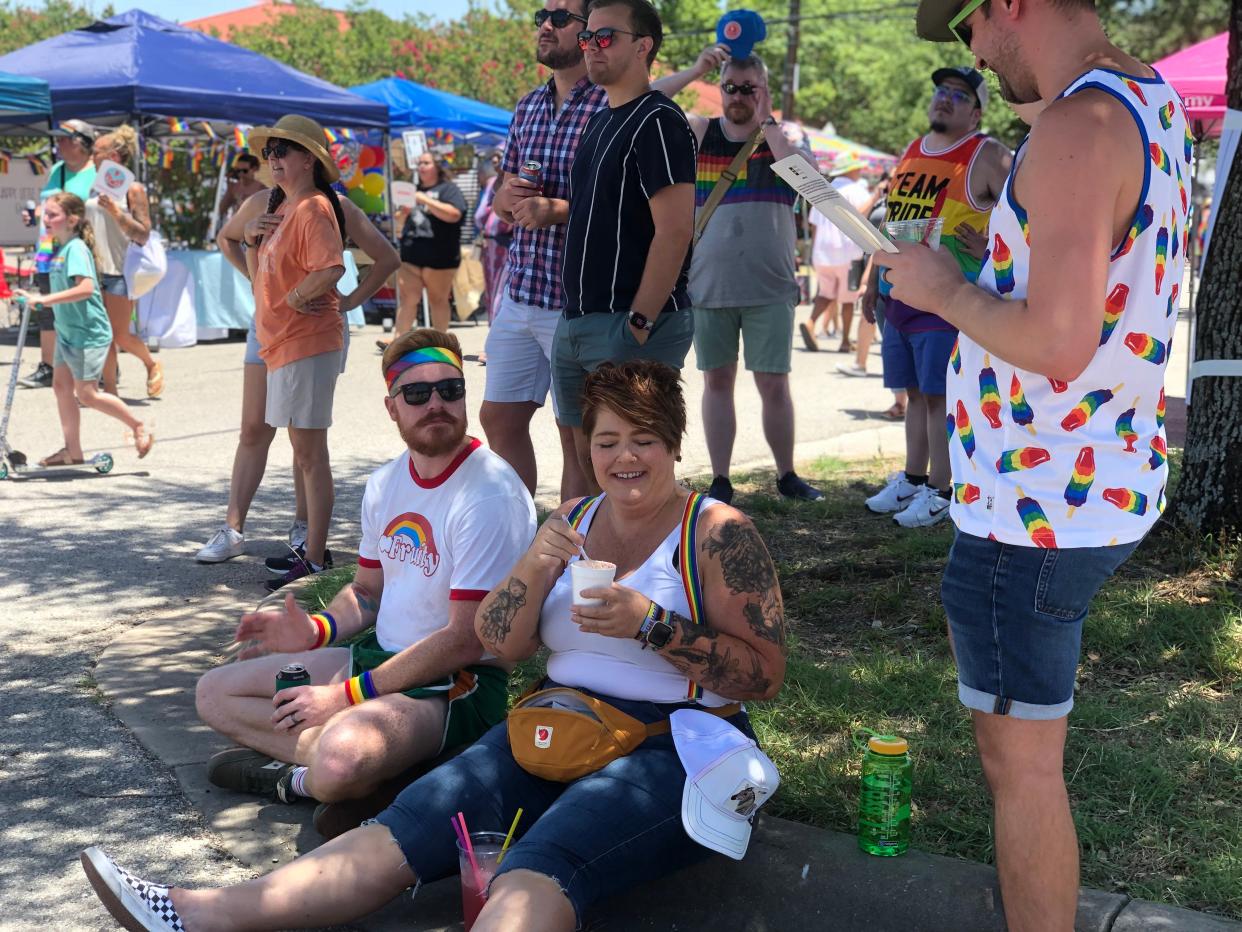 Joshua Dunham, left, and Amber Richardson () sit under the shade at the first Gay Pride event in Pflugerville on June 18.