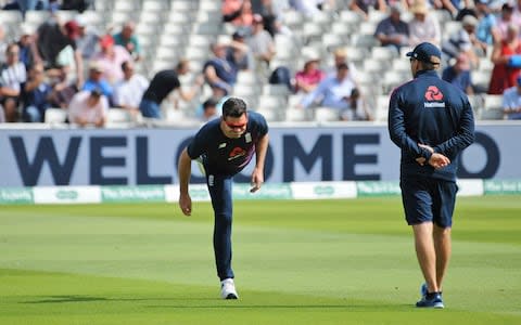 England's James Anderson performs stretch exercises to test his injury during the second day of the first Ashes Test cricket match between England and Australia - Credit: AP Photo/Rui Vieira