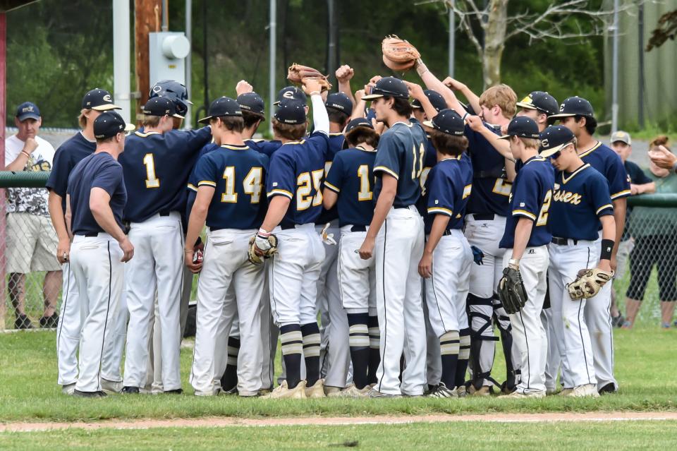 The Essex Hornets gather between innings to talk it over during their D1 semifinal game vs the CVU Redhawks on Tuesday afternoon in Hinesburg.