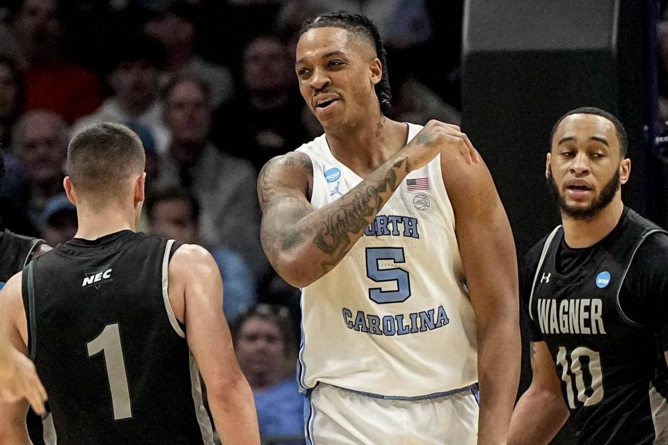 North Carolina forward Armando Bacot (5) reacts to being fouled while making the basket against Wagner during the first half of a first-round college basketball game in that NCAA Tournament, Thursday, March 21, 2024, in Charlotte, N.C. (AP Photo/Mike Stewart)