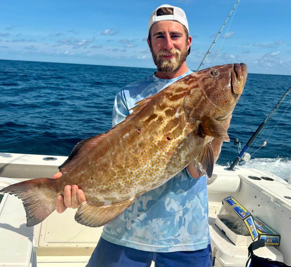 Morgan Harlan, of KC Sportfishing, holds up a monster 30-pound gag grouper.