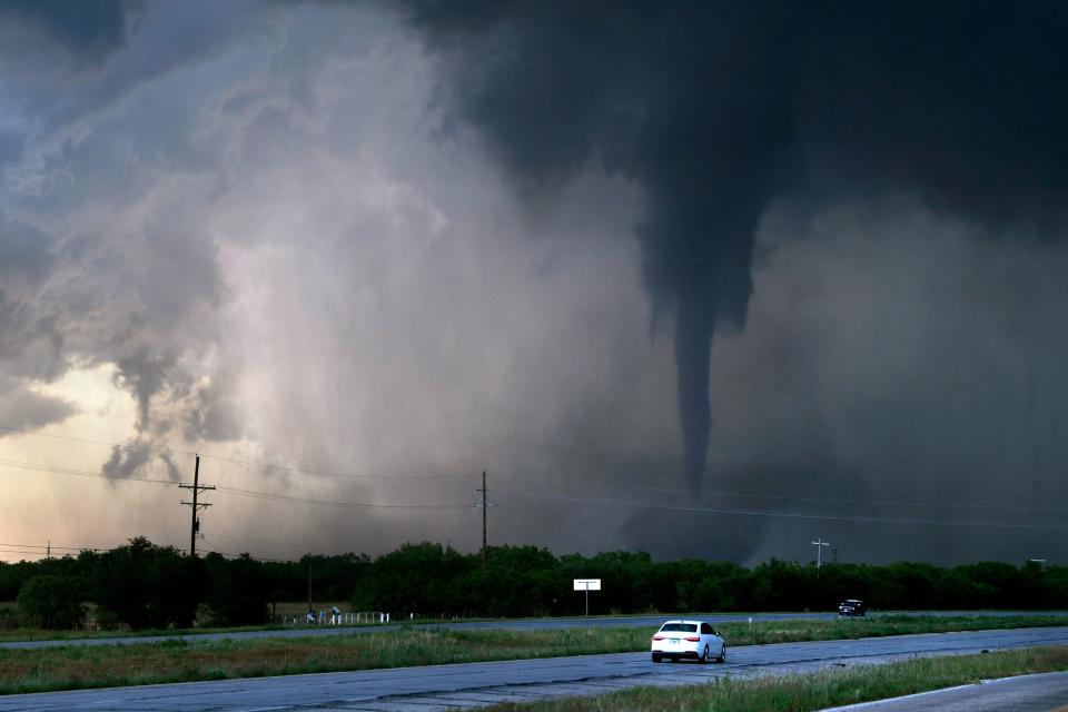 A tornado spins west of Hawley, Texas as cars pass on U.S. 277 May 2, 2024. Damage was reported in Hawley with hail reported up to baseball size.