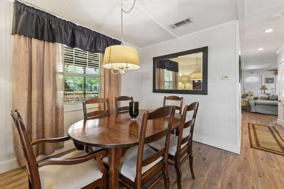 The dining area of Breezy Porches is open and sits beside the kitchen in the Waveland home. MS Real Estate Photography