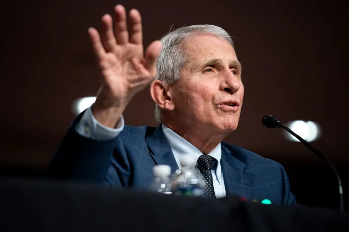 Dr. Anthony Fauci raises right hand as he testifies at a Senate Health, Education, Labor, and Pensions Committee hearing on Capitol Hill.