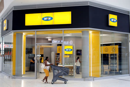 FILE PHOTO: A shopper walks past an MTN shop at a mall in Johannesburg, South Africa, March 2, 2017. REUTERS/Siphiwe Sibeko/File Photo