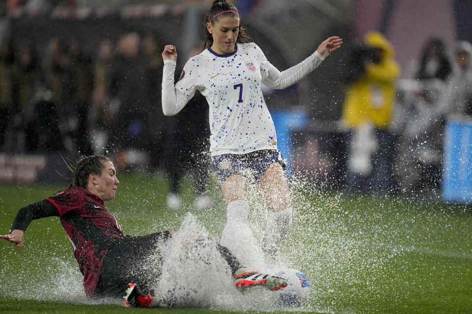 United States' Alex Morgan, above, collides with Canada's Vanessa Gilles during the first half of a CONCACAF Gold Cup women's soccer tournament semifinal match, Wednesday, March 6, 2024, in San Diego. (AP Photo/Gregory Bull)