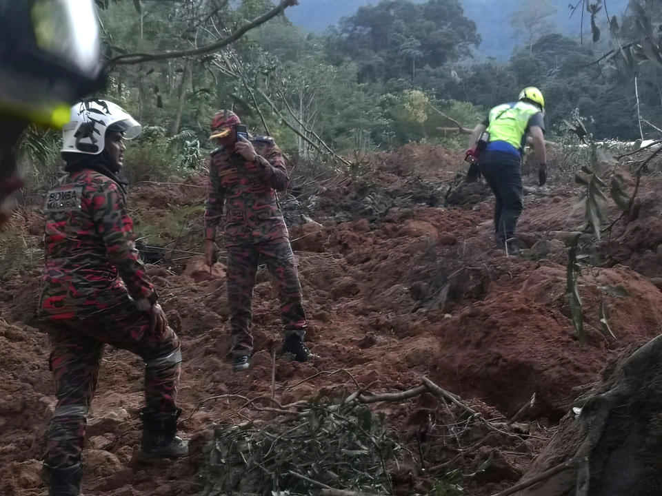 In this photo released by Korporat JBPM, rescuers work during a rescue and evacuation operation following a landslide at a campsite in Batang Kali, Selangor state, on the outskirts of Kuala Lumpur, Malaysia, Dec. 16, 2022. (Korporat JBPM via AP)