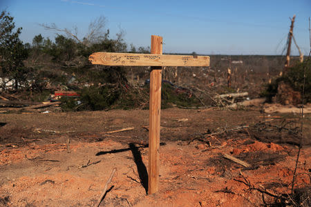 A gravesite for two dogs buried sits outside a home, where one person perished, after two deadly back-to-back tornadoes, in Beauregard, Alabama, U.S., March 6, 2019. REUTERS/Shannon Stapleton