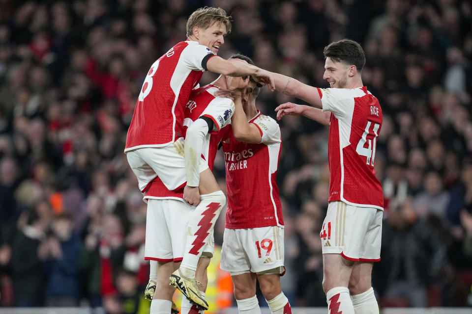 Arsenal's Kai Havertz celebrates with teammates after scoring his side's fourth goal during the English Premier League soccer match between Arsenal and Chelsea at Emirates Stadium in London, Tuesday, April 23, 2024. (AP Photo/Kin Cheung)