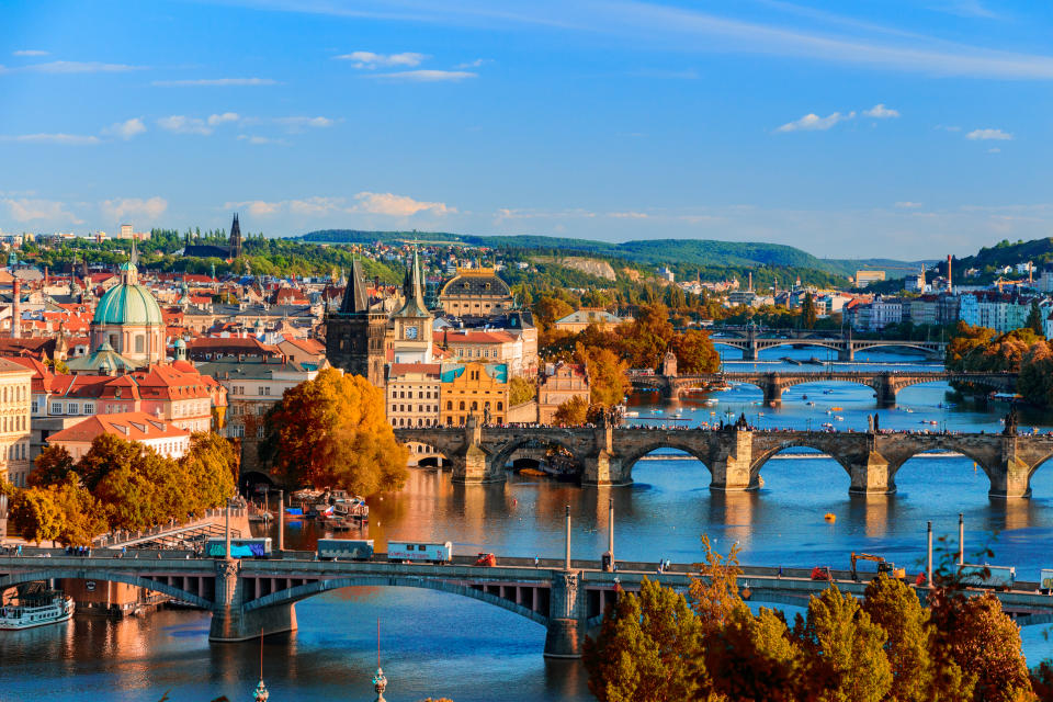 View of the Vltava River and Charle bridge with red foliage, Prague, Czech Republic. Photo: Getty