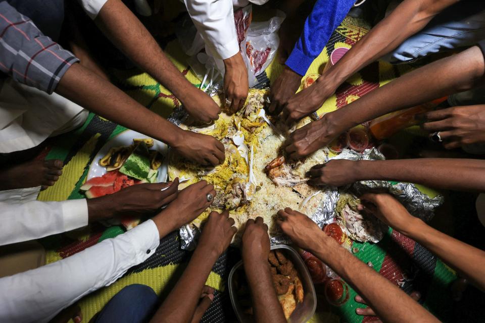 Sudanese men gather for iftar, fast-breaking meal, during the Muslim holy fasting month of Ramadan in a park in Khartoum in 2023.